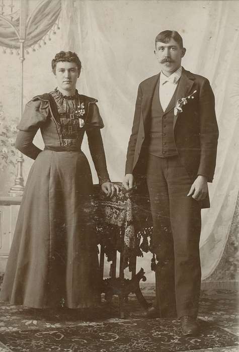 Portraits - Group, cabinet photo, floor cloth, Weddings, Iowa, couple, table, woman, Iowa History, Olsson, Ann and Jons, tablecloth, Cedar Falls, IA, painted backdrop, man, rug, history of Iowa, corsage, wedding