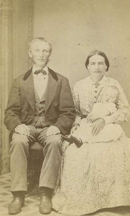 baby, woman, earrings, frock coat, patterned carpet, Children, hoop skirt, family, man, brooch, history of Iowa, Iowa History, Portraits - Group, carte de visite, Iowa, child, couple, vest, Olsson, Ann and Jons, dress, Ackley, IA