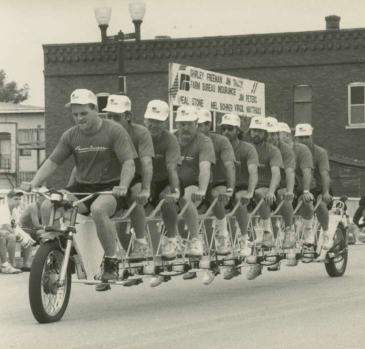 Cities and Towns, men, bicycle, baseball cap, Waverly Public Library, Main Streets & Town Squares, Iowa, Fairs and Festivals, sign, history of Iowa, Iowa History, Waverly, IA, silly