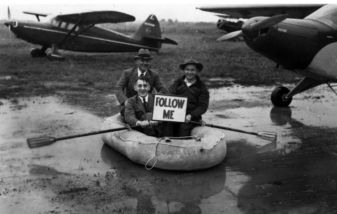 Portraits - Group, mud, plane, Ottumwa, IA, Iowa History, history of Iowa, Lemberger, LeAnn, Motorized Vehicles, airplane, puddle, Iowa, oar, boat, sign, silly, Leisure