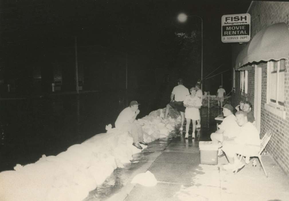 Portraits - Group, sandbags, Floods, history of Iowa, Iowa History, storefront, Businesses and Factories, Civic Engagement, Iowa, Cities and Towns, street flooded, Waverly Public Library