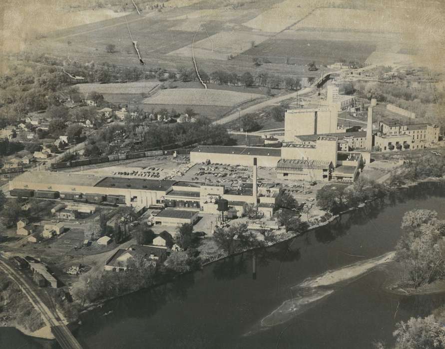 history of Iowa, Businesses and Factories, Waverly, IA, tree, Waverly Public Library, Iowa, car, river, Aerial Shots, parking lot, building, Iowa History, Cities and Towns, Lakes, Rivers, and Streams