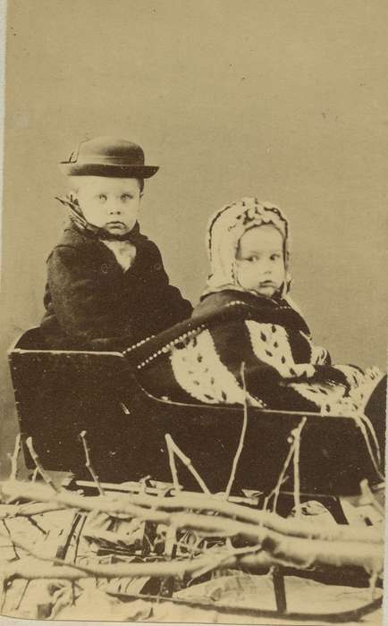 Portraits - Group, boy, carte de visite, Iowa, branches, bonnet, hat, children, Children, Olsson, Ann and Jons, Independence, IA, Winter, history of Iowa, siblings, Iowa History, sled