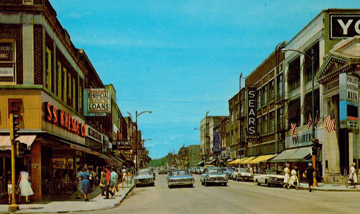 flag, mainstreet, Main Streets & Town Squares, history of Iowa, Iowa History, Ottumwa, IA, Lemberger, LeAnn, storefront, Motorized Vehicles, Businesses and Factories, car, department store, Iowa, Cities and Towns, stoplight, bank