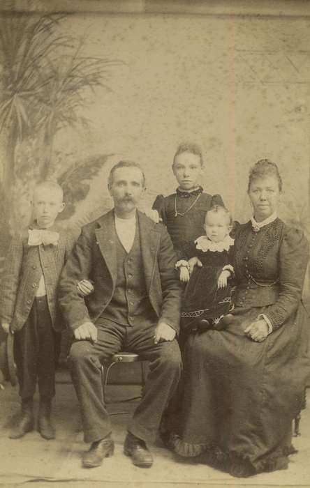 Portraits - Group, cabinet photo, father, Iowa History, family, painted backdrop, Families, history of Iowa, baby, brothers, Davenport, IA, Iowa, mother, Olsson, Ann and Jons, sister, Children, jewelry, bow tie