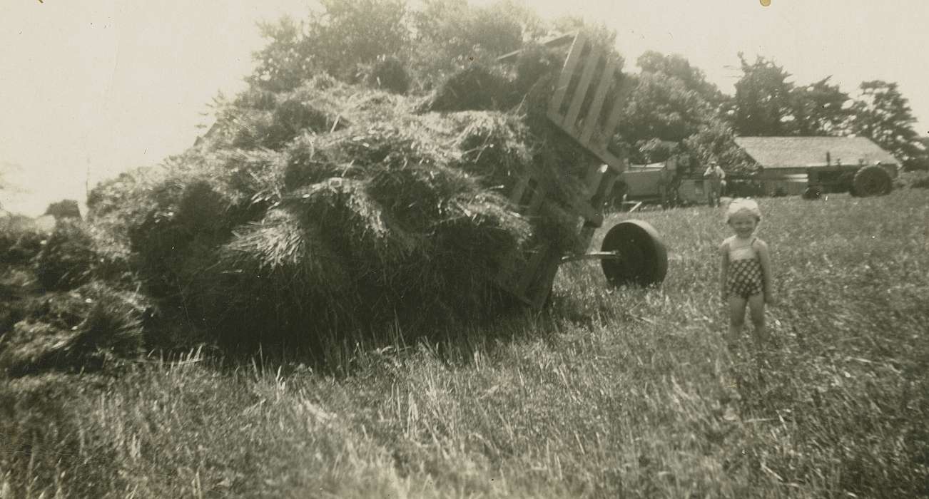 hay, summer, history of Iowa, Williamsburg, IA, Farms, accident, Iowa, smile, field, Skoog, Herb, Portraits - Individual, hay bale, Children, Iowa History, wagon, Farming Equipment, tractor