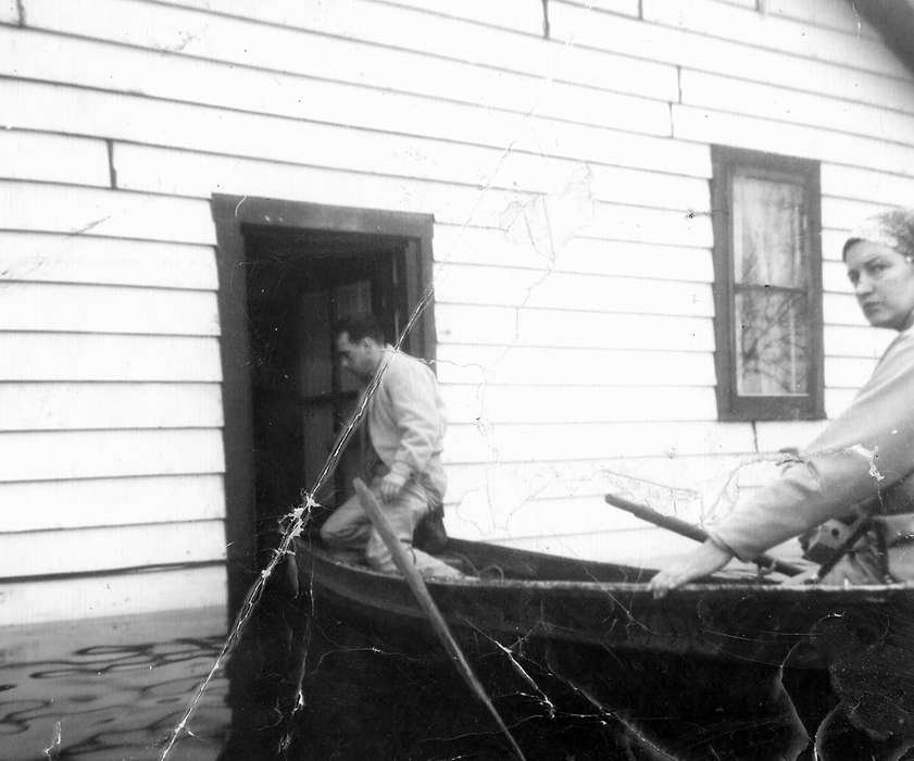 men, Iowa, boat, float, Homes, paddles, women, doorway, door, wooden house, Dubuque, IA, history of Iowa, Floods, Iowa History, Gilbertson, Becky