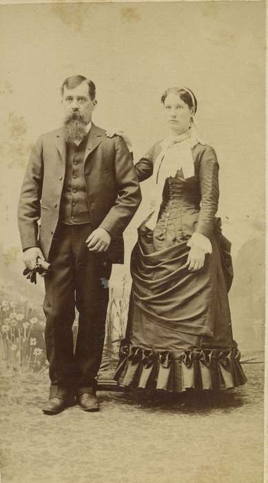 collared dresses, carte de visite, sack coat, beard, Olsson, Ann and Jons, bustle, ribbon, history of Iowa, couple, vest, Iowa, mustache, Des Moines, IA, man, Iowa History, woman, Portraits - Group, painted backdrop