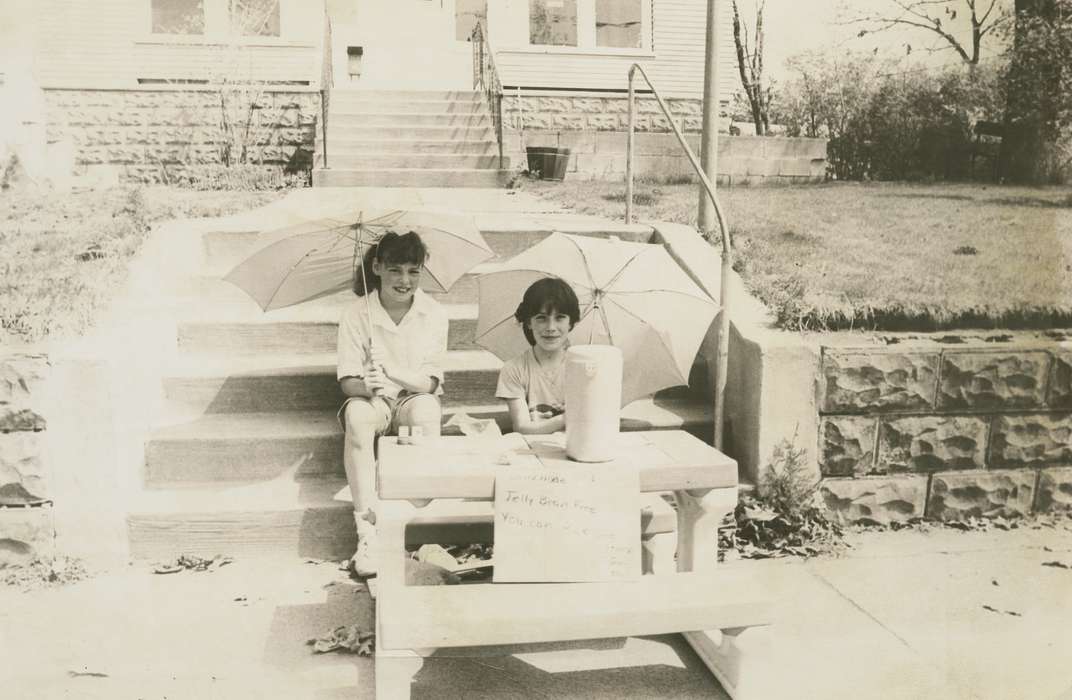 Portraits - Group, history of Iowa, Iowa History, picnic table, lemonade stand, Businesses and Factories, front yard, front steps, girls, sidewalk, umbrella, Iowa, Cities and Towns, Homes, house, Food and Meals, Children, Waverly Public Library