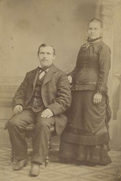 Olsson, Ann and Jons, Cedar Rapids, IA, bustle, bow tie, ribbon, history of Iowa, pocket watch chain, couple, earrings, Iowa, frock coat, cabinet photo, mustache, Iowa History, woman, Portraits - Group, painted backdrop