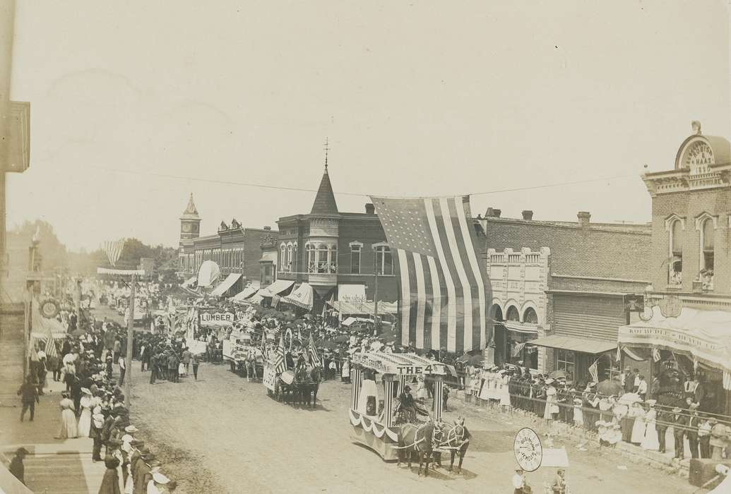 parade, clock tower, Businesses and Factories, Animals, american flag, umbrella, Cities and Towns, awning, horse, Waverly Public Library, electrical pole, Main Streets & Town Squares, history of Iowa, Iowa History, Entertainment, brick building, clock, crowd, dirt street, Aerial Shots, parade float, Iowa, carriage, correct date needed
