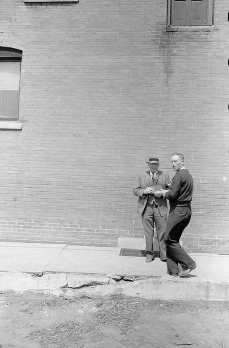 Portraits - Group, history of Iowa, conversation, Iowa History, Library of Congress, brick building, sidewalk, man, Iowa, Cities and Towns, suit, broken sidewalk
