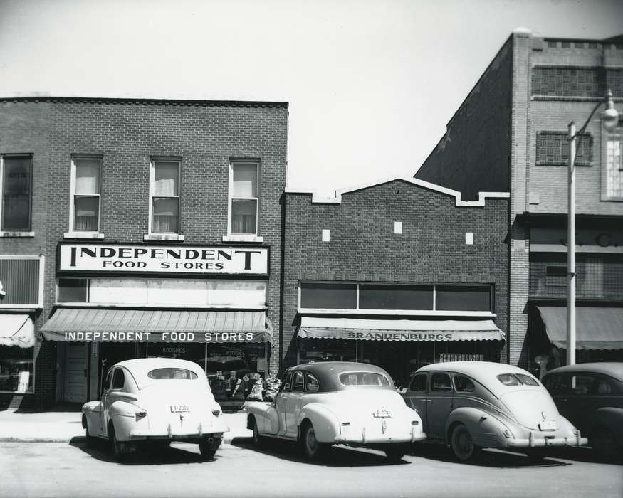 license plate, Main Streets & Town Squares, history of Iowa, Iowa History, Motorized Vehicles, Businesses and Factories, window, brick building, car, window display, Waverly, IA, building, Iowa, Cities and Towns, sign, Waverly Public Library