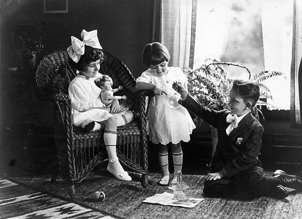 Portraits - Group, sisters, glass, Early, IA, ornaments, hair bow, siblings, brother, wicker, history of Iowa, Iowa History, playing, ball, doll, Iowa, wicker chair, Homes, Scherrman, Pearl, Children, ornament