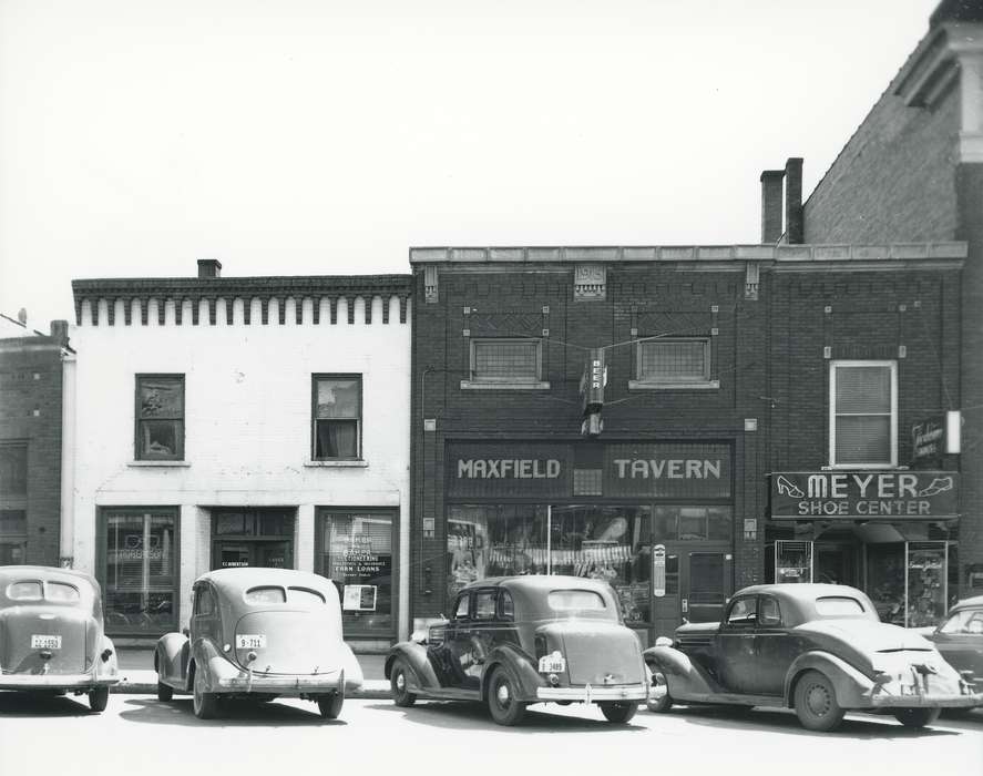 license plate, sign, history of Iowa, door, window, Businesses and Factories, Waverly, IA, Waverly Public Library, Main Streets & Town Squares, window display, car, Motorized Vehicles, Iowa, brick building, building, Iowa History, Cities and Towns