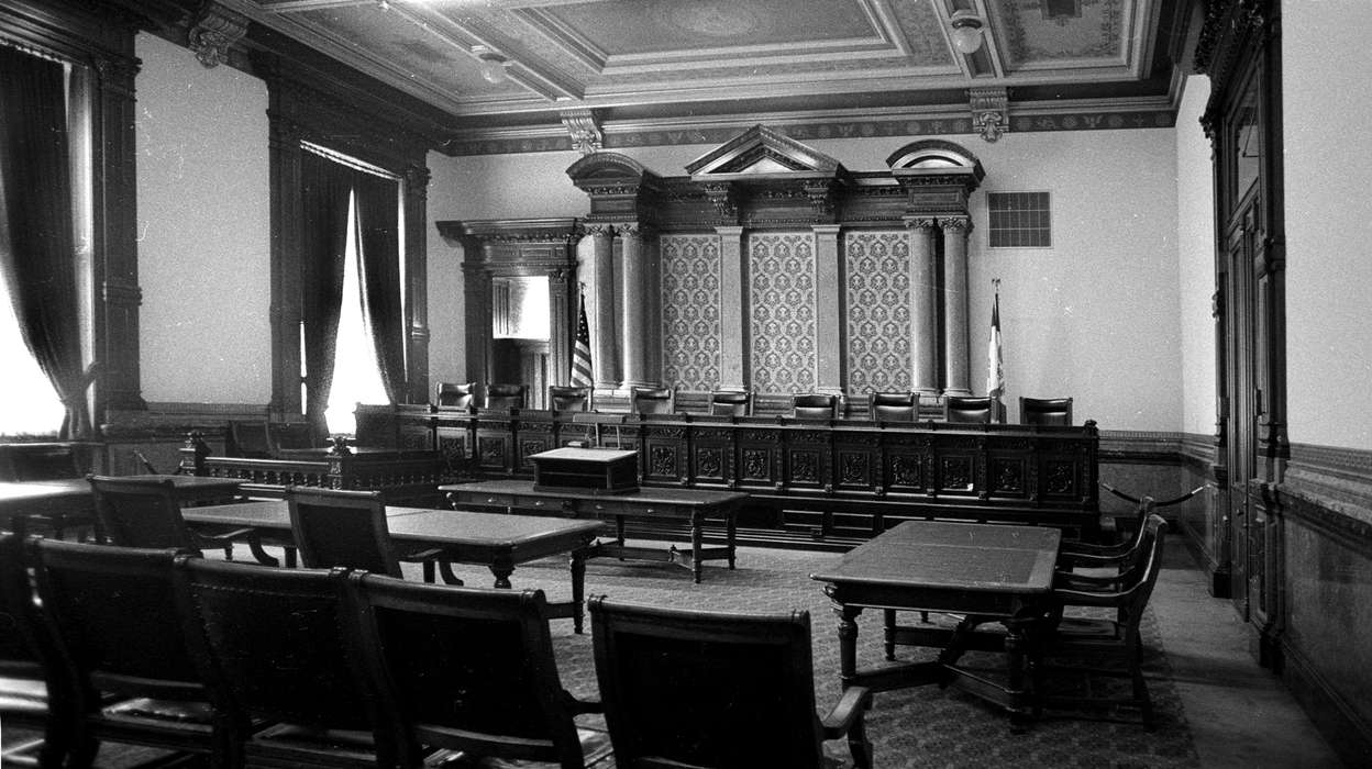 flag, table, history of Iowa, Iowa History, Lemberger, LeAnn, Prisons and Criminal Justice, american flag, chair, Iowa, desk, Cities and Towns, curtain, court room, Des Moines, IA