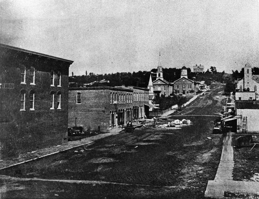 steeple, Main Streets & Town Squares, history of Iowa, Religious Structures, Ottumwa, IA, Iowa History, Lemberger, LeAnn, Businesses and Factories, store, courthouse, dirt road, Iowa, Cities and Towns, hill, church