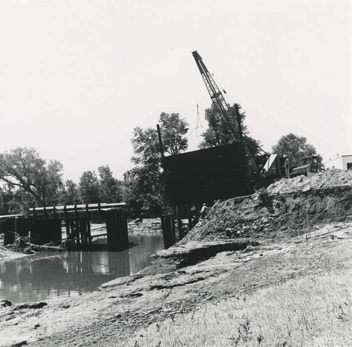 history of Iowa, Lakes, Rivers, and Streams, Waverly Public Library, Iowa, river, Motorized Vehicles, construction crew, Iowa History, Floods, flood aftermath, cedar river, summer, construction, crane, Labor and Occupations, Waverly, IA, hard hat, tree, bridge