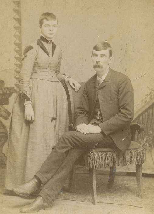 Portraits - Group, fringe, Iowa, couple, woman, chair, watch chain, Olsson, Ann and Jons, Quasqueton, IA, painted backdrop, man, mustache, history of Iowa, cabinet photo, Iowa History