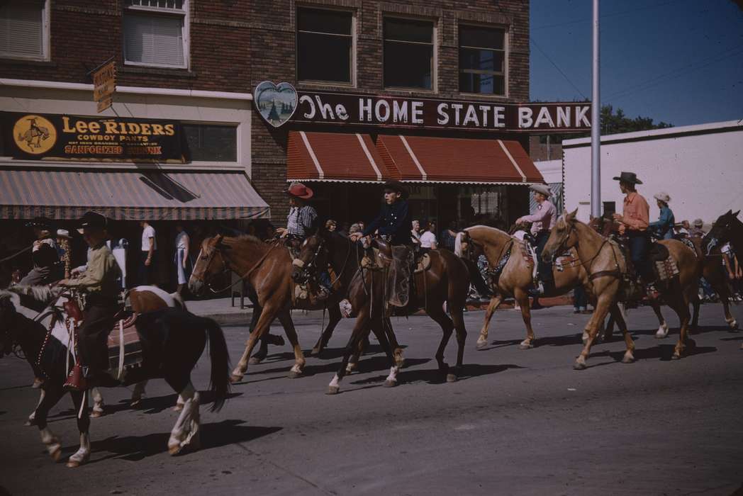 cowboy, Main Streets & Town Squares, history of Iowa, advertisement, Sack, Renata, Entertainment, parade, Iowa History, Animals, cowboy hat, Fairs and Festivals, USA, horse racing, Iowa, store front, horse, bank