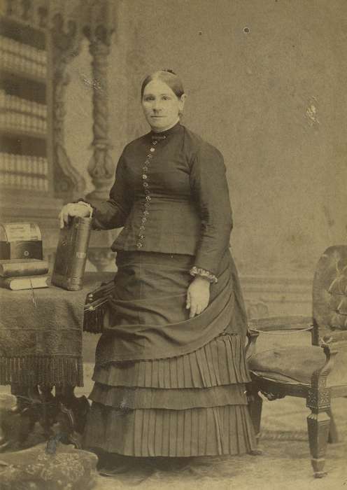 brooch, photo album, table, history of Iowa, Iowa History, Anamosa, IA, woman, Olsson, Ann and Jons, books, chair, cabinet photo, Iowa, painted backdrop, tablecloth, Portraits - Individual