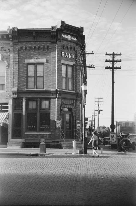 Library of Congress, electrical pole, street corner, history of Iowa, Businesses and Factories, sidewalk, Main Streets & Town Squares, Iowa, Motorized Vehicles, american legion post, lamppost, cobblestone street, brick building, Iowa History, Cities and Towns, power lines, cars, bank