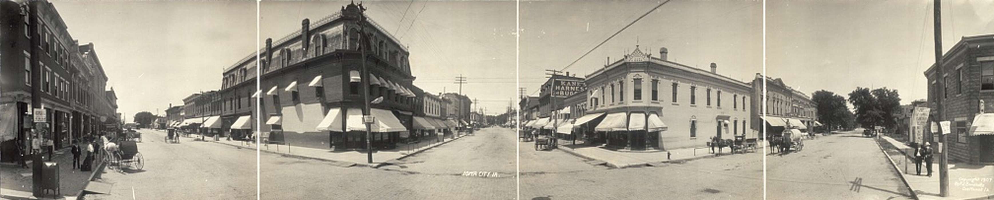 cobblestone street, Library of Congress, brick building, panorama, Animals, Main Streets & Town Squares, Iowa, Cities and Towns, Families, Businesses and Factories, pedestrian, man, woman, electrical pole, sidewalk, kids, storefront awning, history of Iowa, power lines, horse and cart, horse and buggy, Leisure, Labor and Occupations, Children, horse, Iowa History, Portraits - Group