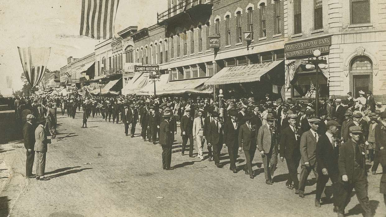 Iowa, parade, storefront, veranda, Iowa History, hat, Entertainment, Cities and Towns, Anamosa, IA, Hatcher, Cecilia, history of Iowa, flag, Main Streets & Town Squares, suit