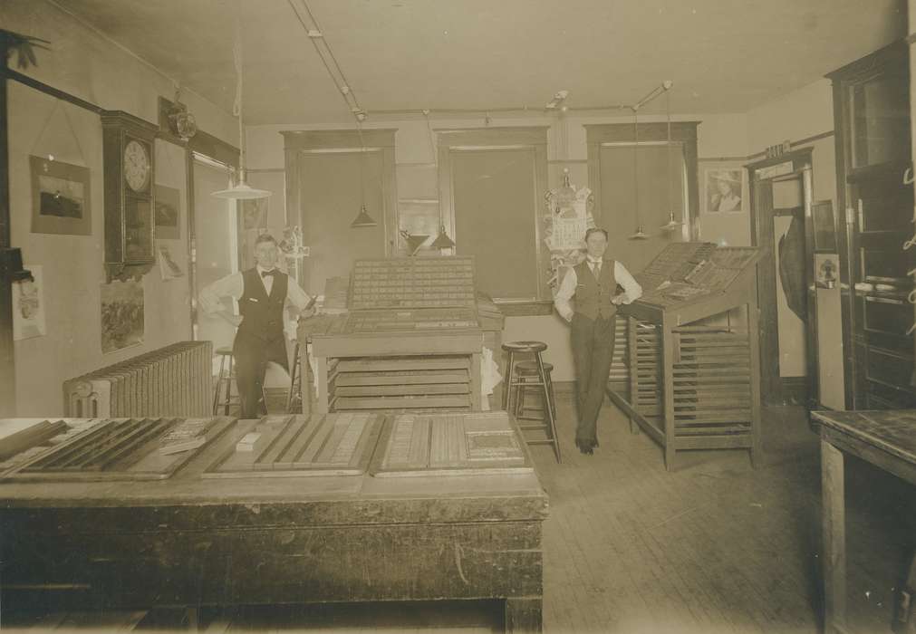 businessman, tables, business owner, radiator, bow tie, posters, history of Iowa, phoenix german newspaper, family business, Iowa History, Portraits - Group, Waverly Public Library, correct date needed, calendar, Iowa, clock, Businesses and Factories, newspaper, portrait, suits, Labor and Occupations, stool, Waverly, IA, lights, office