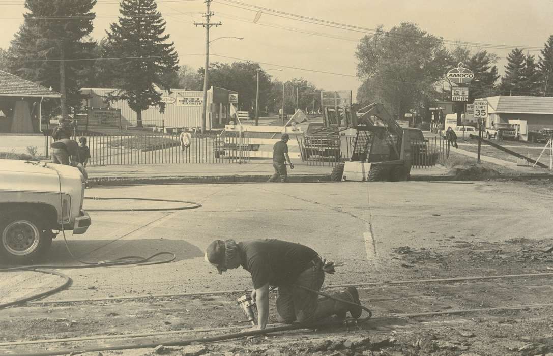 truck, Businesses and Factories, car, gas station, Cities and Towns, lamppost, street, Waverly Public Library, Main Streets & Town Squares, history of Iowa, Iowa History, gas pump, Motorized Vehicles, train track, Waverly, IA, forklift, Iowa, fence, sign, construction crew, Labor and Occupations