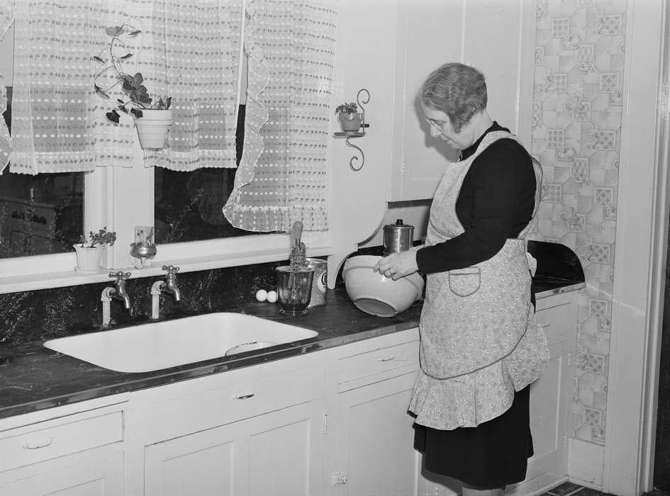 hand mixer, countertop, Library of Congress, tile, curtains, crisco, Iowa, counter, apron, woman, baking, Homes, history of Iowa, house plant, cupboard, faucet, curtain, sink, Iowa History