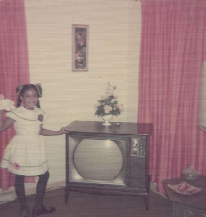 Barrett, Sarah, smile, Leisure, Children, african american, Homes, People of Color, history of Iowa, Iowa History, easter, television, home, Iowa, tv, child, Waterloo, IA, living room, Portraits - Individual, girl