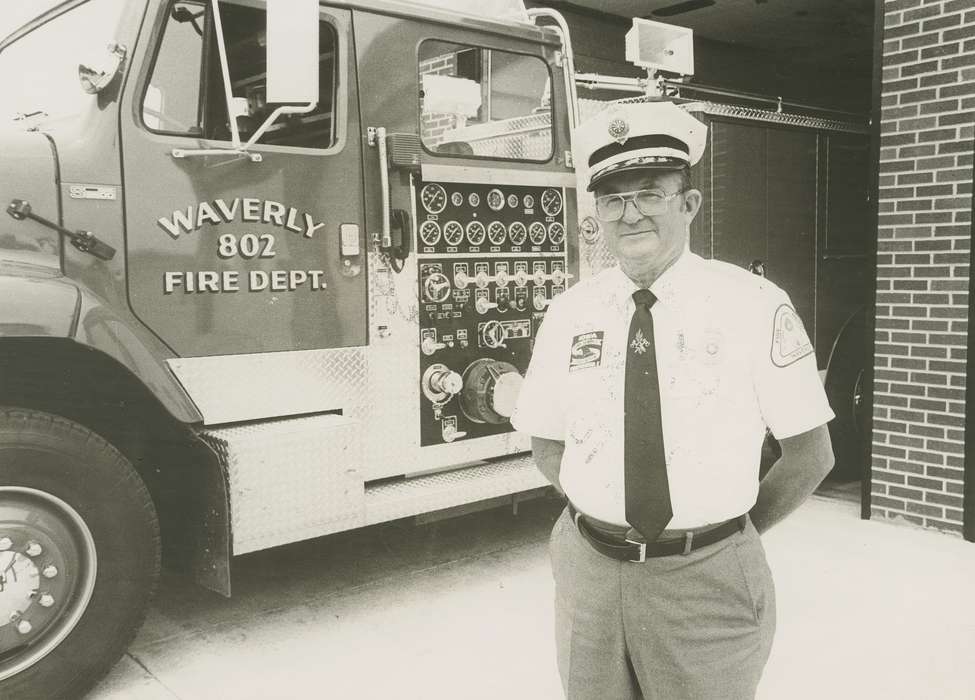 Portraits - Individual, history of Iowa, fire truck, uniform, Waverly, IA, Waverly Public Library, Iowa, Motorized Vehicles, brick building, chief, Iowa History, glasses, fire station