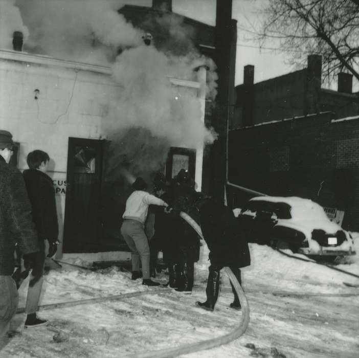 hose, history of Iowa, fireman, hardware store, Businesses and Factories, snow, Waverly Public Library, Iowa, firefighter, smoke, Winter, Iowa History, Labor and Occupations, Wrecks