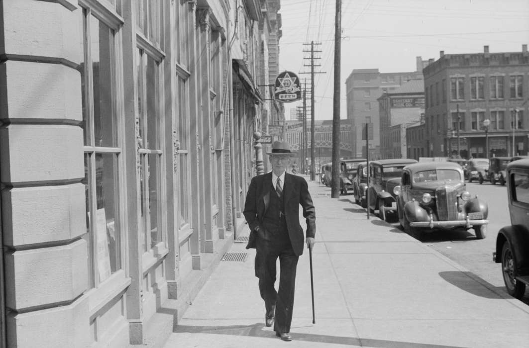 Cities and Towns, Portraits - Individual, handsome, suit, tie, cane, history of Iowa, Library of Congress, Iowa, sidewalk, chevrolet, man, Iowa History, Businesses and Factories, spiffy, car