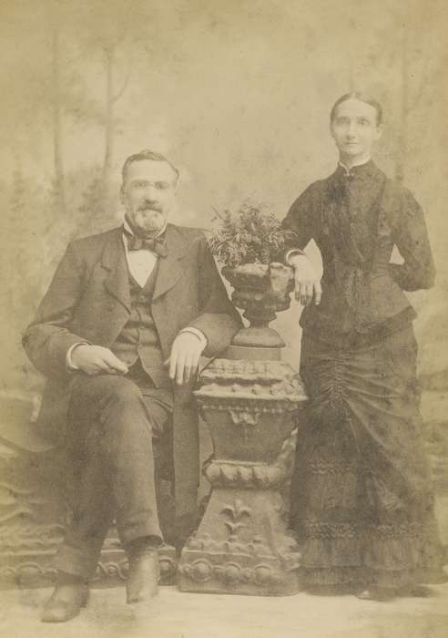 Portraits - Group, cabinet photo, Iowa, Cedar Rapids, IA, vest, couple, woman, Iowa History, frock coat, Olsson, Ann and Jons, dress, history of Iowa, painted backdrop, man, brooch, bow tie, suit