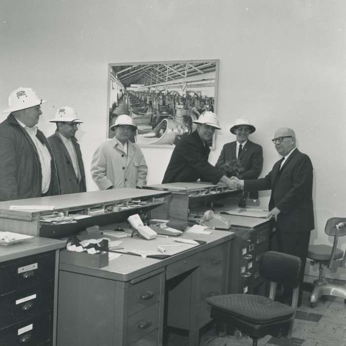 file cabinet, hard hat, telephone, suit, Waverly, IA, Iowa History, Waverly Public Library, glasses, man, Iowa, desk, correct date needed, calendar, Portraits - Group, history of Iowa, businessman, office chair, photograph