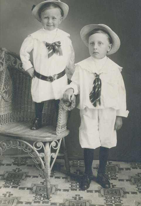 Portraits - Group, history of Iowa, Iowa History, children, patterned carpet, Waverly, IA, knickers, boys, Iowa, wicker chair, straw hat, Children, Waverly Public Library