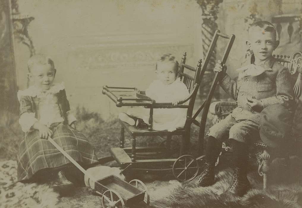 Portraits - Group, boy, cabinet photo, Iowa, toy, Families, Children, Olsson, Ann and Jons, toddler, painted backdrop, Anamosa, IA, siblings, history of Iowa, wooden chair, high chair, Iowa History, little lord fauntleroy suit