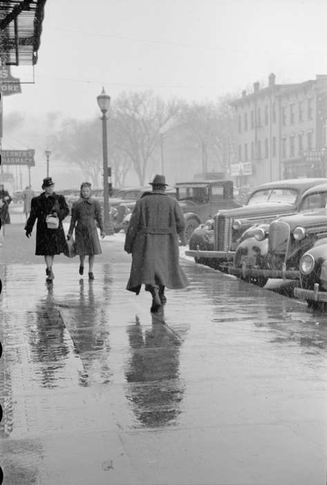 Cities and Towns, storefront, Motorized Vehicles, walking, Winter, Children, snow day, main street, Main Streets & Town Squares, street parking, Library of Congress, Iowa, sidewalk, history of Iowa, Iowa History, Businesses and Factories, trench coat