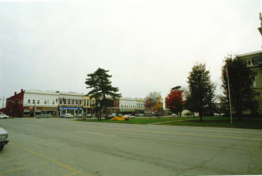 flag, Main Streets & Town Squares, Bloomfield, IA, history of Iowa, Iowa History, Lemberger, LeAnn, storefront, Motorized Vehicles, Businesses and Factories, flagpole, car, Iowa, Cities and Towns