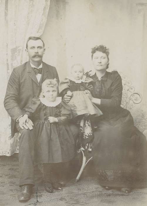 Portraits - Group, bow tie, Families, girl, patterned carpet, siblings, man, cabinet photo, mustache, Kimballton, IA, sack coat, history of Iowa, Iowa History, woman, wicker chair, Olsson, Ann and Jons, Iowa, family, painted backdrop, Children