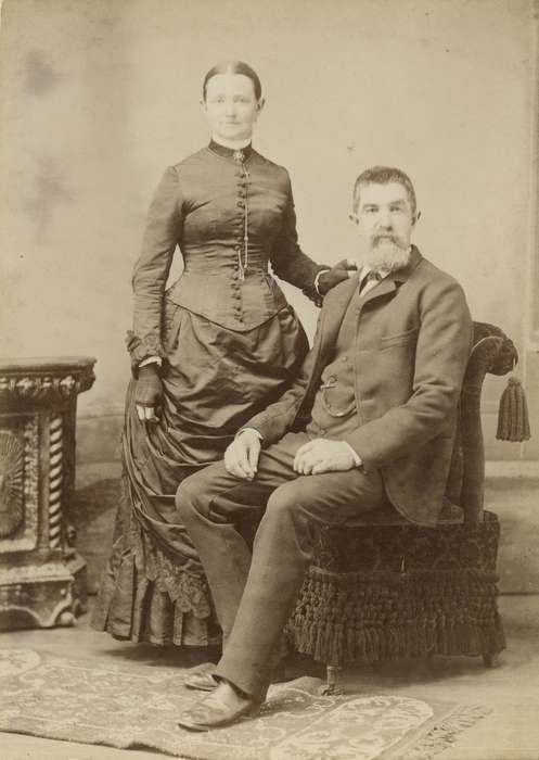 Portraits - Group, Iowa, couple, woman, Iowa History, fingerless mitts, chair, watch chain, lace, Olsson, Ann and Jons, dress, Davenport, IA, history of Iowa, pleats, man, brooch, cabinet photo, suit