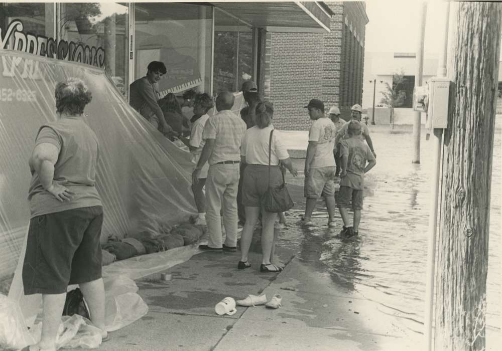 Portraits - Group, Floods, history of Iowa, Iowa History, Businesses and Factories, hard hat, Waverly, IA, tarp, music store, piano, Cities and Towns, sandbagging, Iowa, sandbag, Children, Waverly Public Library, Labor and Occupations