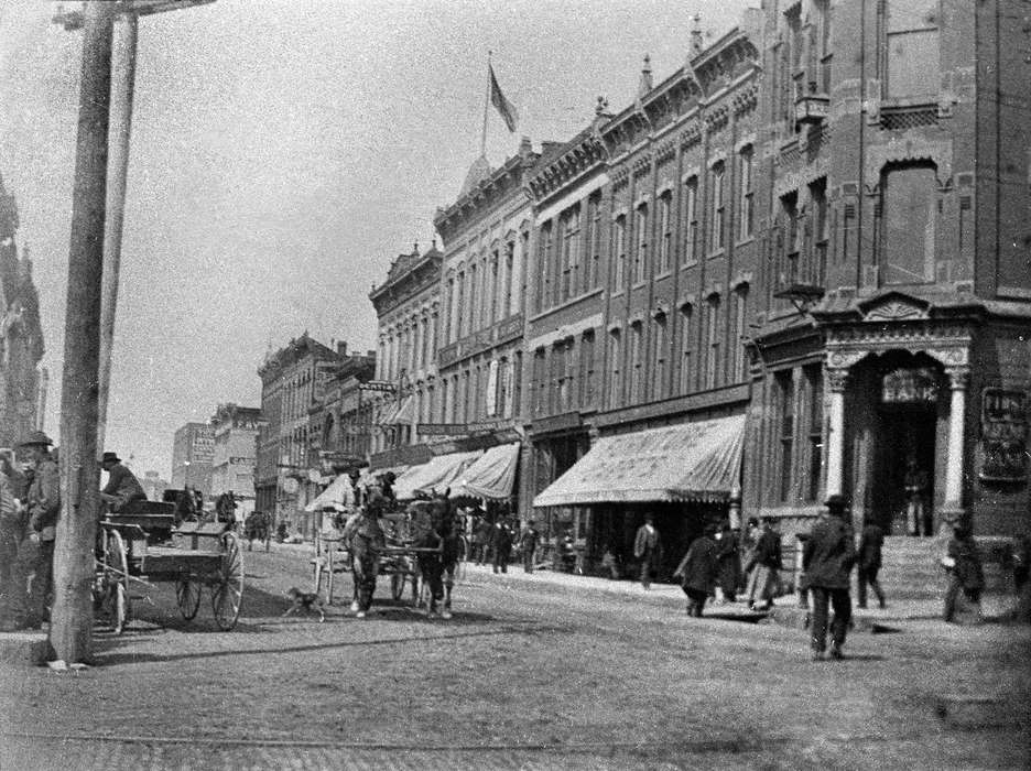 telephone pole, Main Streets & Town Squares, history of Iowa, Iowa History, Ottumwa, IA, Lemberger, LeAnn, Businesses and Factories, Animals, horse and cart, Iowa, Cities and Towns, awning, horse, bank