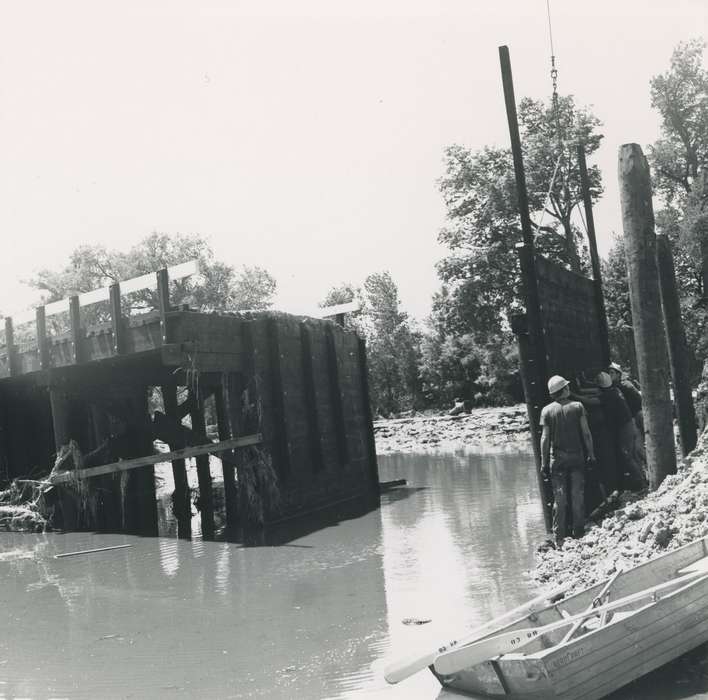 worker, Floods, bridge, Iowa History, history of Iowa, Lakes, Rivers, and Streams, hard hat, flood aftermath, Waverly, IA, Iowa, tree, boat, Waverly Public Library