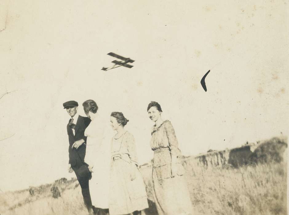 Portraits - Group, suit, newsboy cap, Iowa History, Iowa, Motorized Vehicles, flying, airplane, Crisman, Hannah, dress, correct date needed, history of Iowa, sky