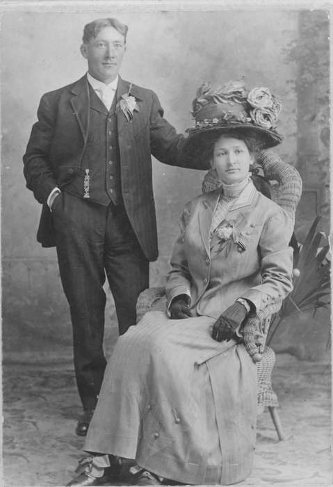 Portraits - Group, Iowa, couple, woman, hat, Cigrand, Mariann, painted backdrop, man, Cascade, IA, history of Iowa, corsage, wicker chair, Iowa History