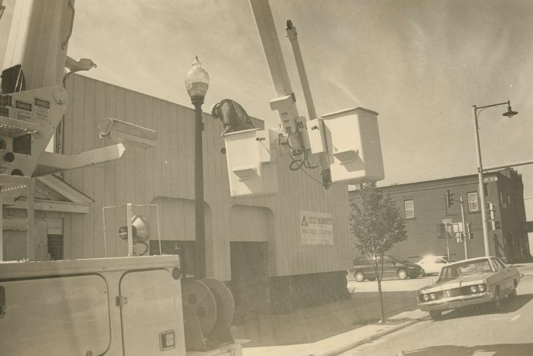 Main Streets & Town Squares, history of Iowa, Portraits - Individual, Iowa History, electric company, utility truck, Motorized Vehicles, Businesses and Factories, sidewalk, car, Iowa, Cities and Towns, lamppost, utility worker, tree, Waverly Public Library, Labor and Occupations