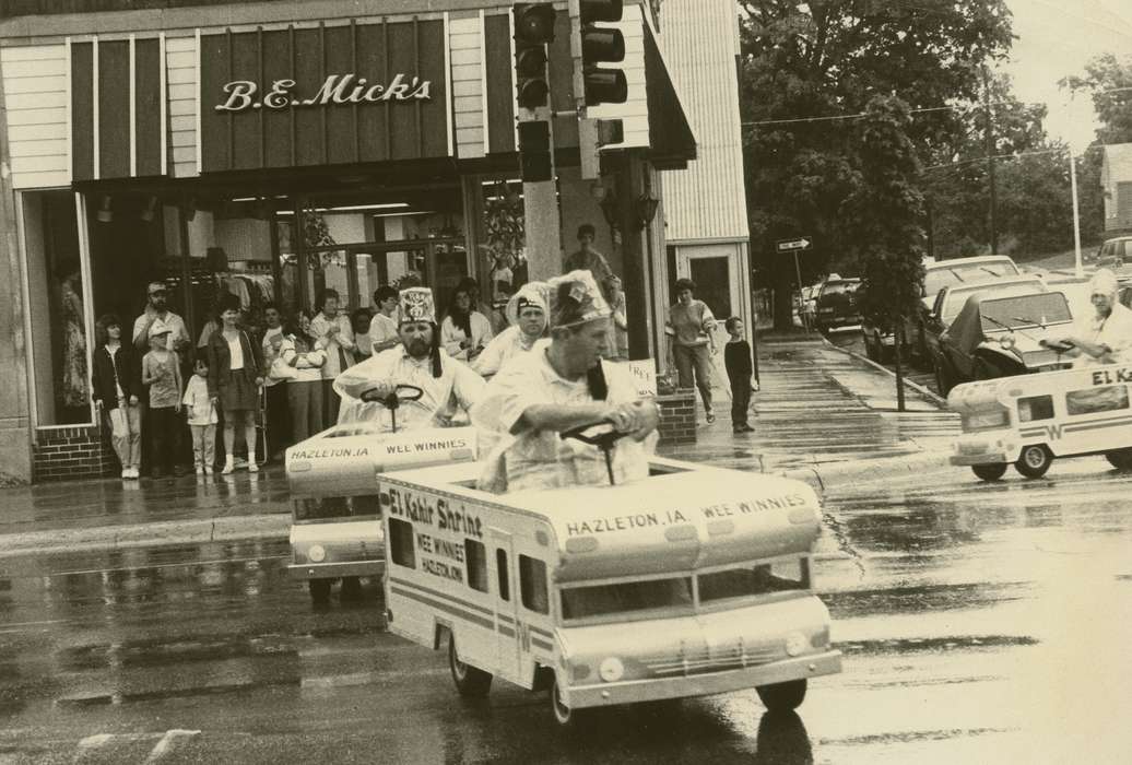 clothing store, parade, Waverly Public Library, shriner, crowd, Waverly, IA, Iowa History, Businesses and Factories, Fairs and Festivals, history of Iowa, Iowa, Motorized Vehicles, Main Streets & Town Squares, Cities and Towns, brick building